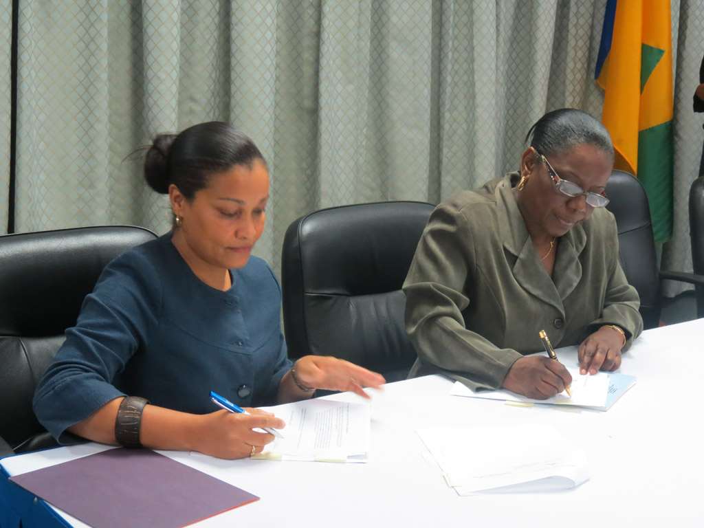 L-R: Laverne Grant, Permanent Secretary, Ministry of Tourism and Laura Anthony-Browne, Director of Central Planning, sign Agreement for the OAS-funded Craft Enhancement project(April 24, 2014)